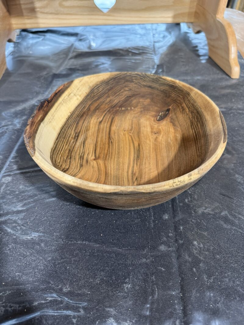 Hand-turned wooden bowl with natural grain