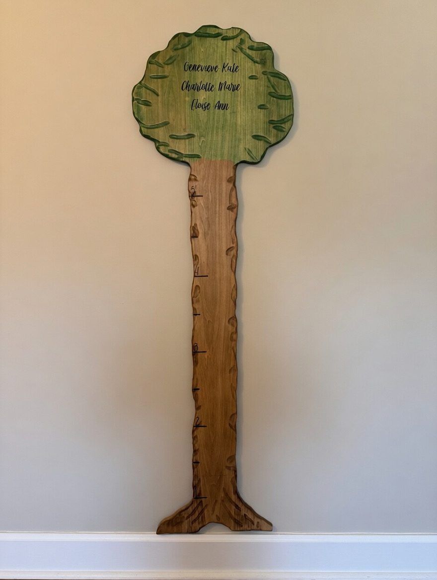Custom wooden growth chart shaped like a tree with personalized names