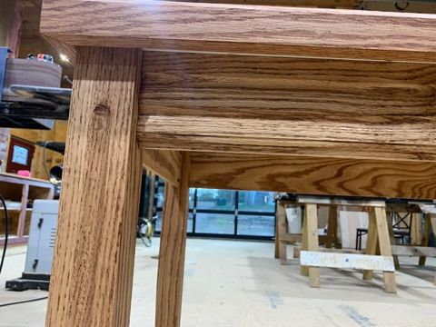 Close-up of oak table leg joinery showing precise craftsmanship