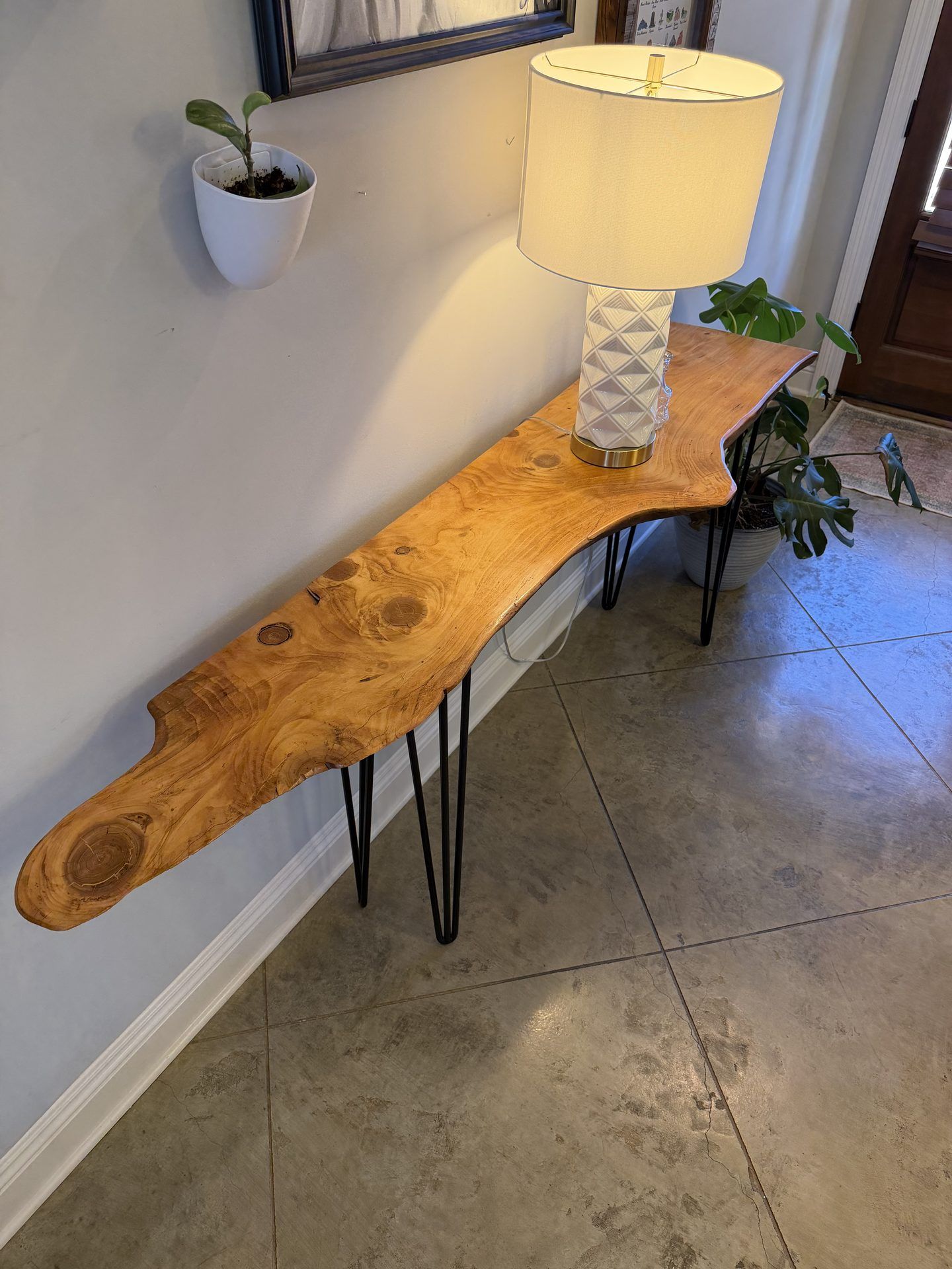 Live-edge wood console table on hairpin legs in a living room