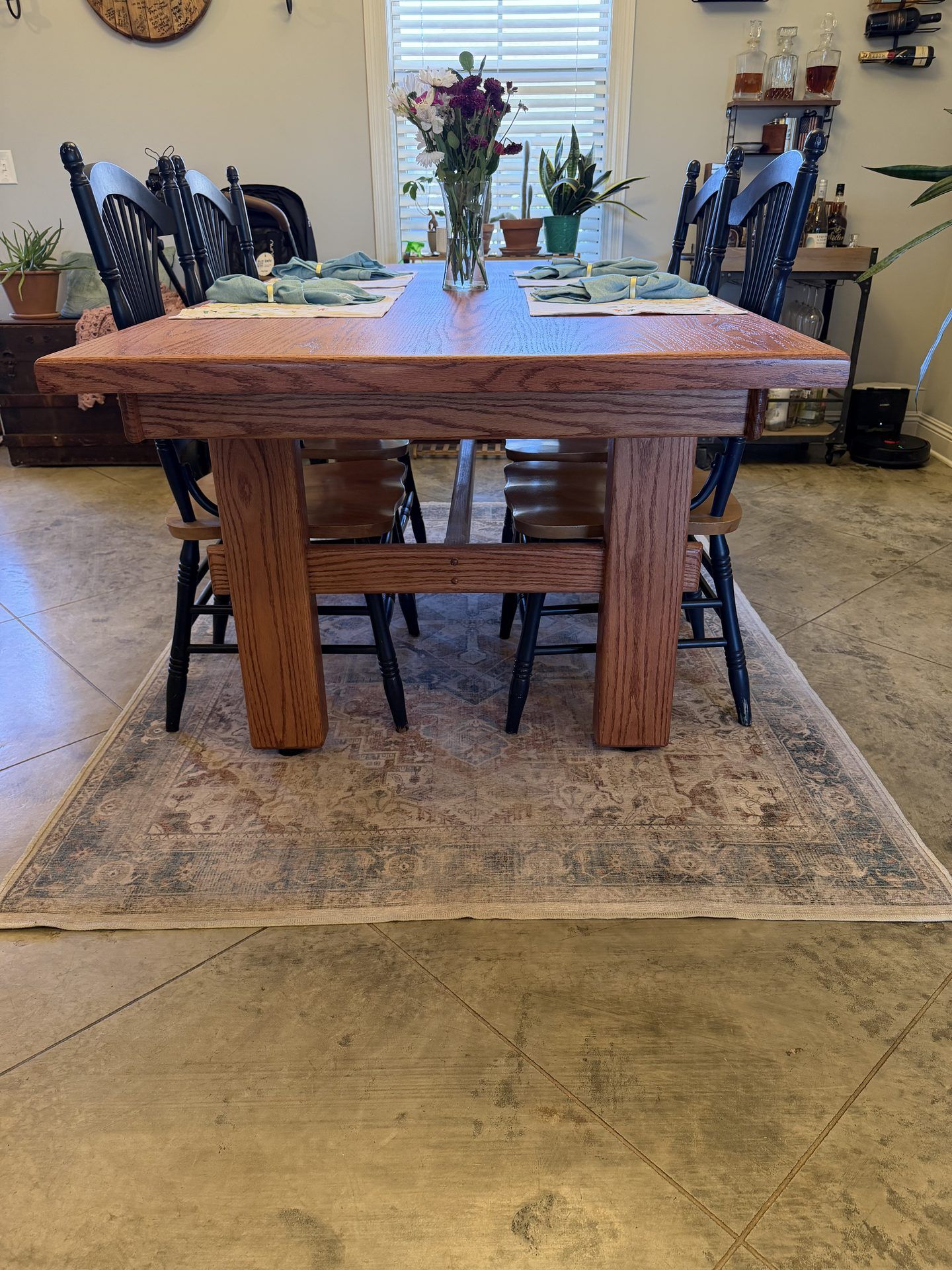 Custom oak dining table in a customer's home with chairs