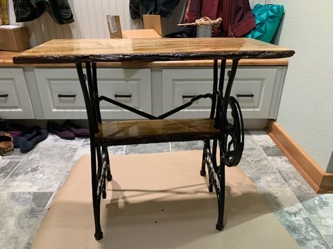 Antique sewing machine base repurposed as side table